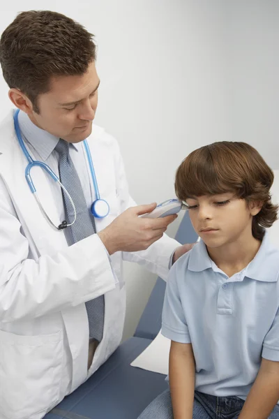 Doctor Taking Boy's Temperature
