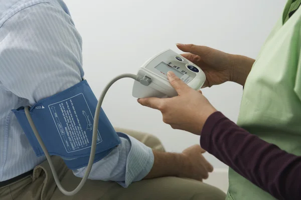 Doctor Checking Patient's Blood Pressure
