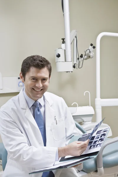 Dentist leafing through medical records