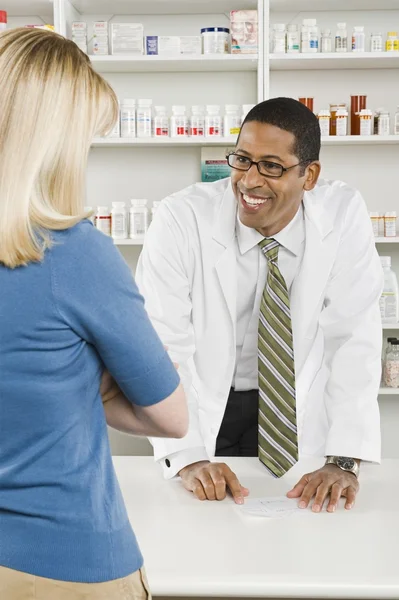 Woman picking up prescription drugs at pharmacy