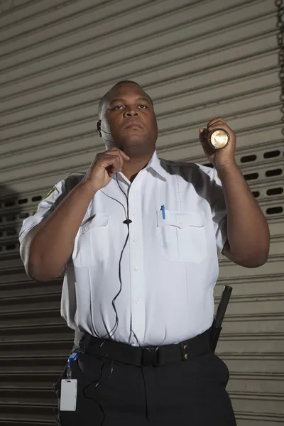 Security Guard Holding A Torch Light
