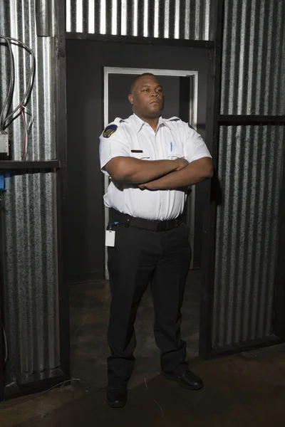 Security Guard Standing With Arms Crossed On Duty