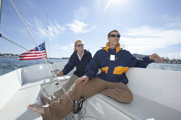 Couple Sailing Together In Boat