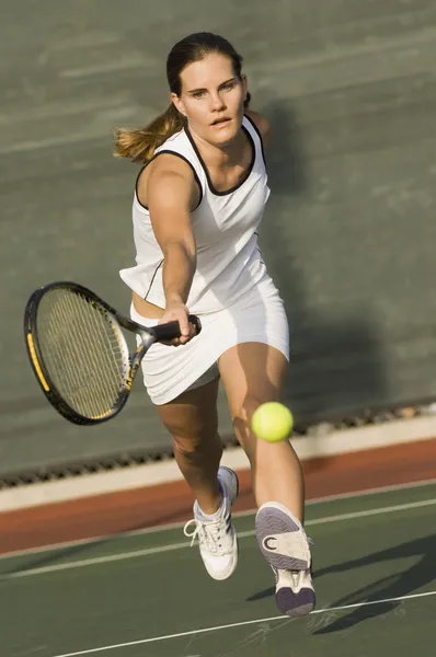 Tennis Player Reaching to hit tennis ball