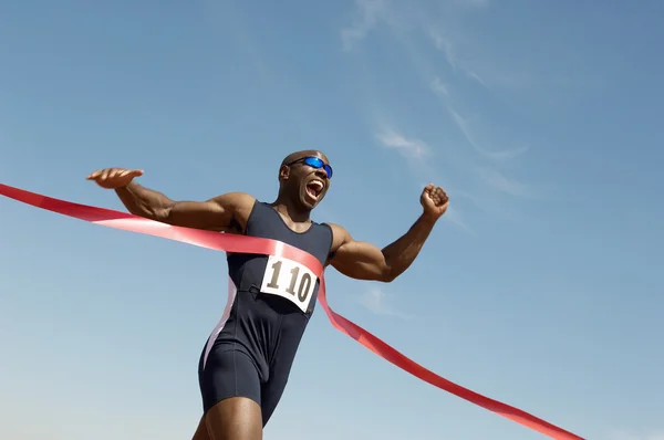 Runner winning race against blue sky