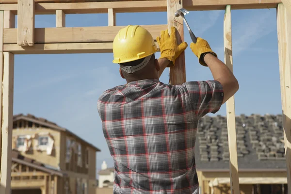 Construction worker working on timber frame