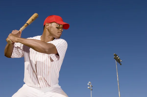 Baseball batter preparing to hit ball