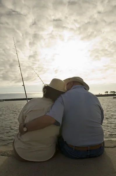Senior couple fishing at ocean
