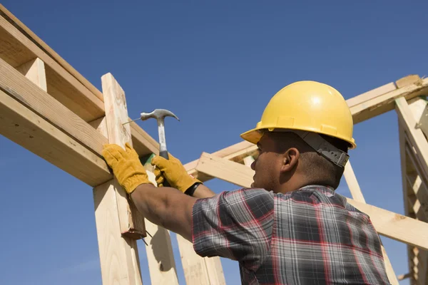 Construction worker hammering nail