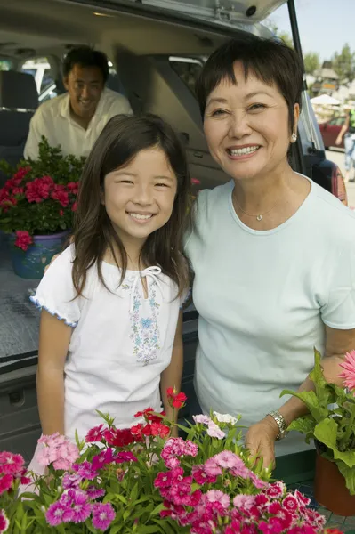 Grandmother and granddaughter with flowers