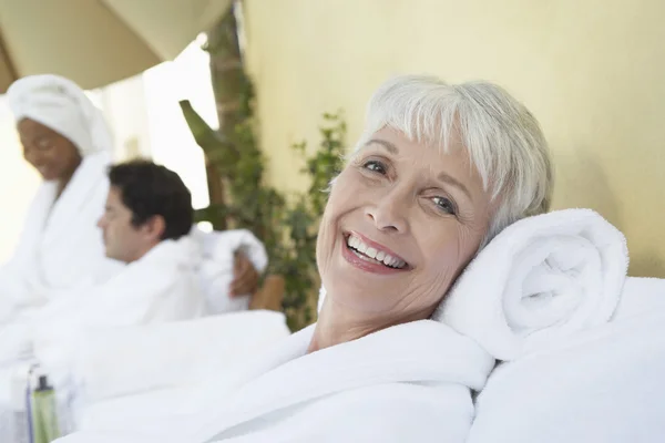 Woman relaxing at spa in bathrobe