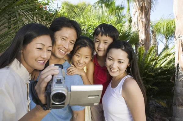 Asian Family Looking at Video Camera