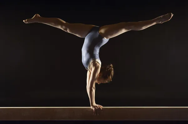 Gymnast doing split handstand