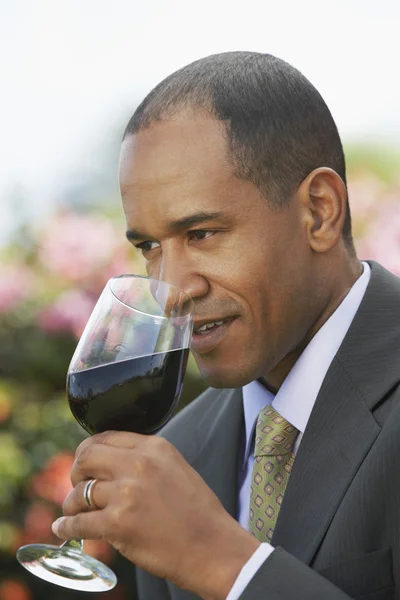 Elegant man tasting red wine