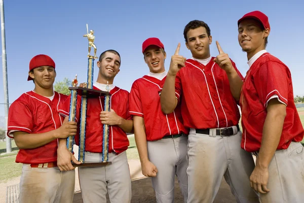 Baseball team with trophy on field