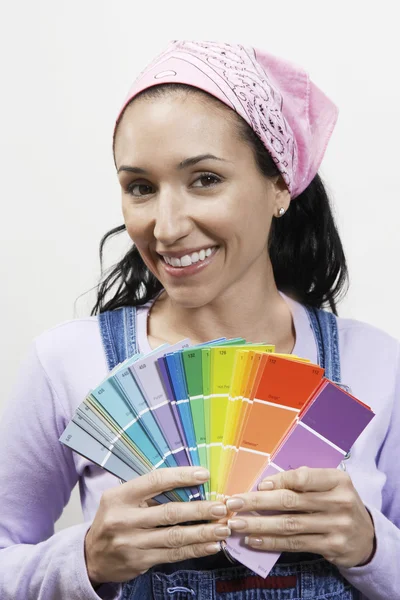 Woman holding paint color samples