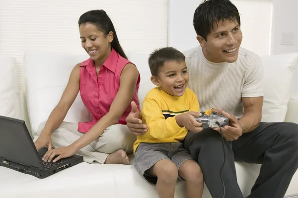 Father playing video game with son
