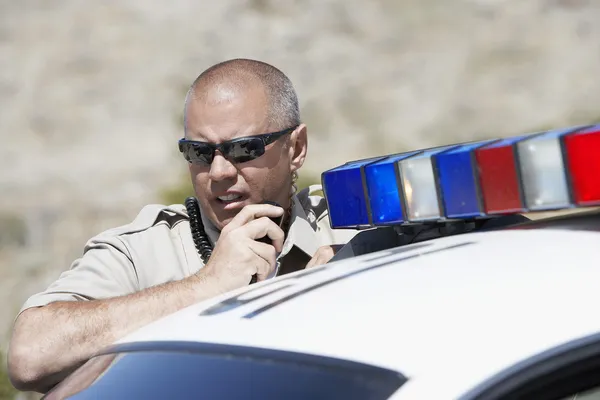 Police officer using two-way radio