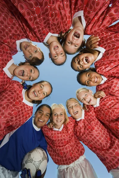 Smiling Girls Soccer Team in Huddle