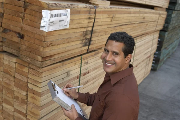 Worker taking notes on clipboard