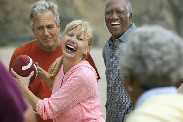 Friends playing American football