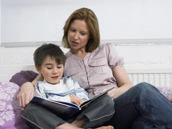 Mother and son reading book