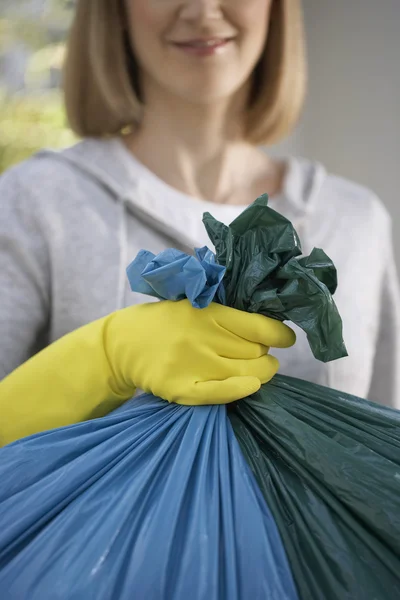 Woman  holding garbage bag