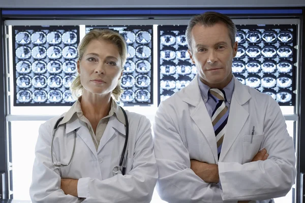 Doctors standing by brain scan