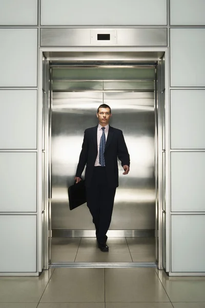 Businessman Exiting Elevator