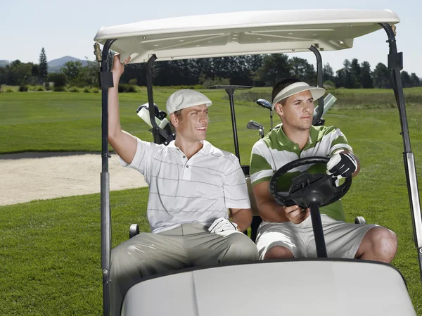 Golfers sitting in cart laughing