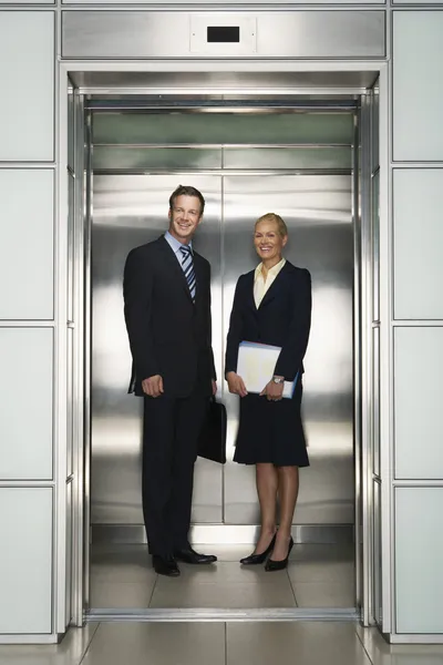 Businessman and Businesswoman in Elevator
