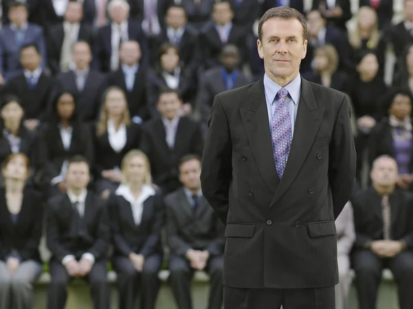 Business man standing in front of people