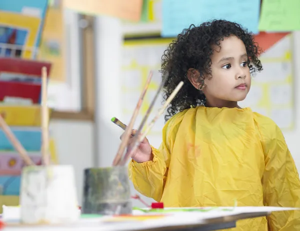 Girl painting in art class