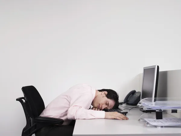 Office worker asleep at desk