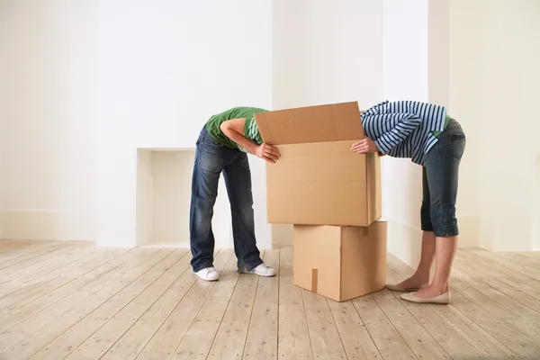 Couple unpacking box in new home