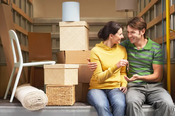 Couple Sitting in Back of Moving Van