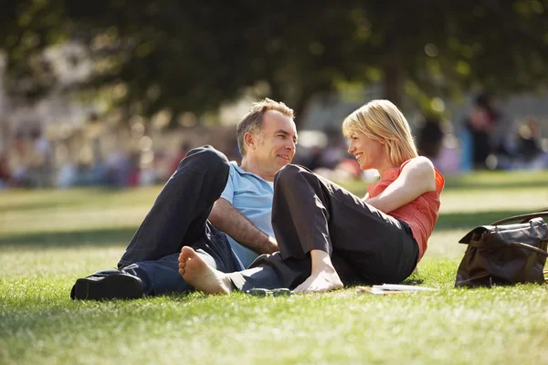 Couple reclining in park