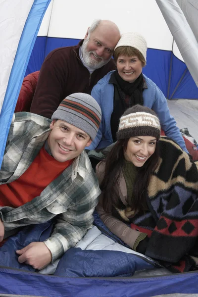 Couples relaxing in tent
