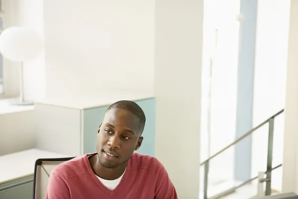 Office worker at desk contemplating