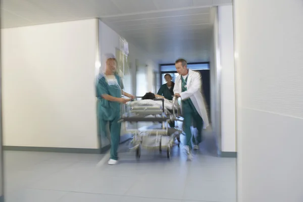 Doctors running Patient on gurney