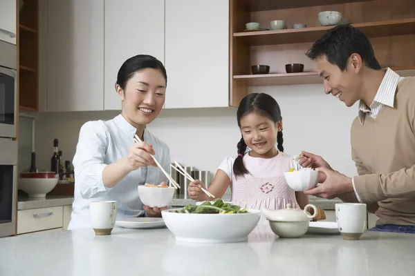 Couple and daughter eating a meal