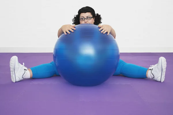 Woman Behind Exercise Ball