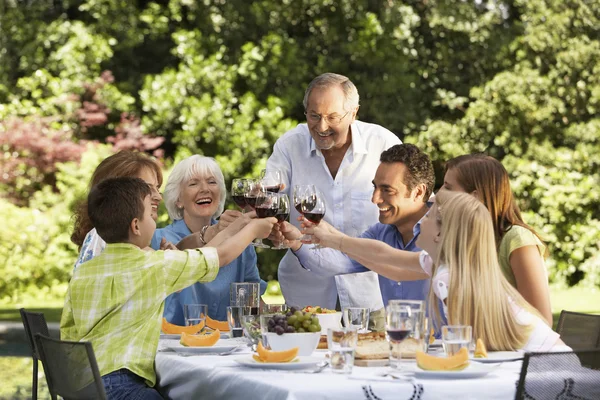 Family toasting at table
