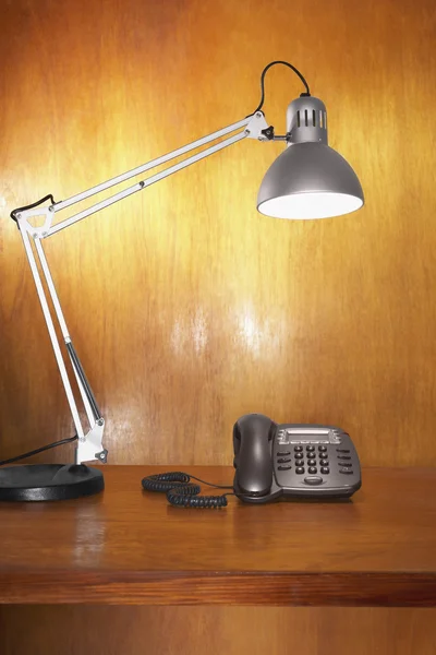 Lamp and telephone on desk