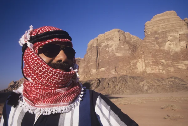 Man in turban standing in desert