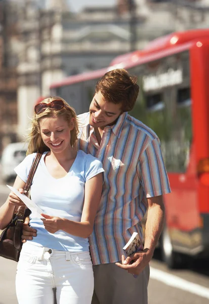 Vacationing couple reading map