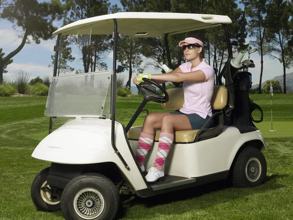Golfer is sitting in cart