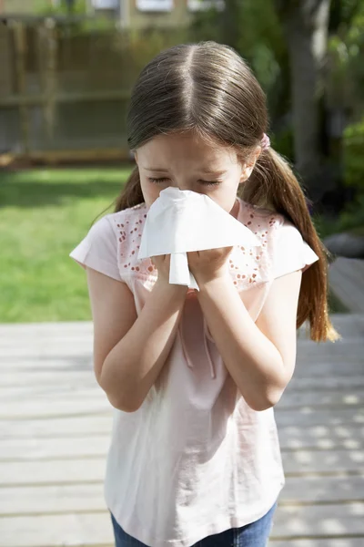 Little girl blowing nose