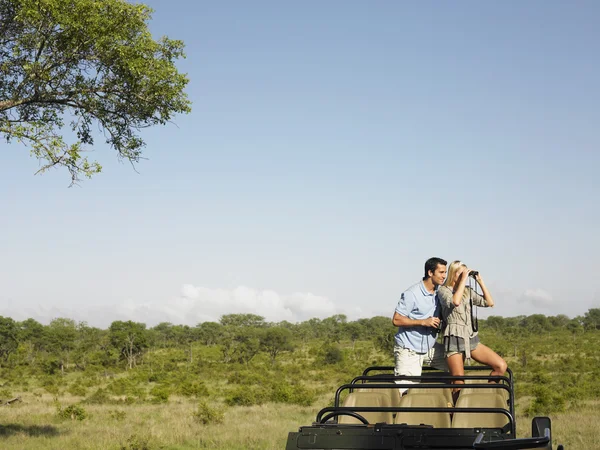 Couple  in safari with binoculars