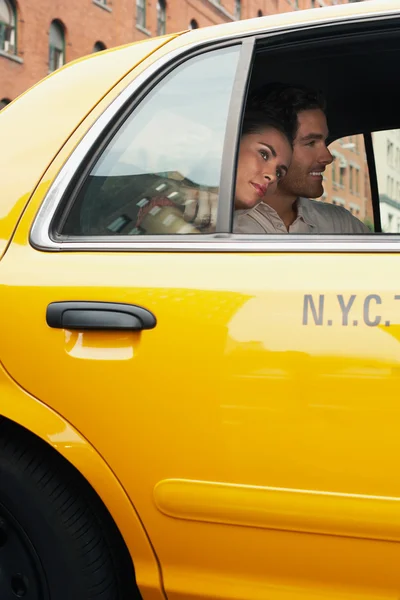 Couple in yellow taxi cab